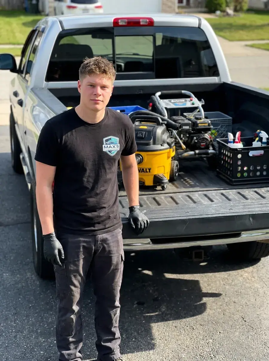 Max — owner of Max's Essential Detailing — standing at the tailgate of his detail truck